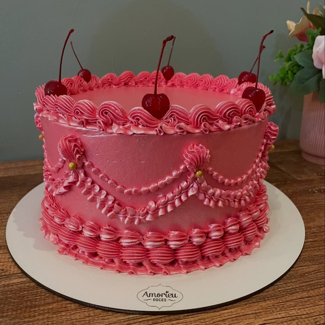 Bolo rosa com cerejas